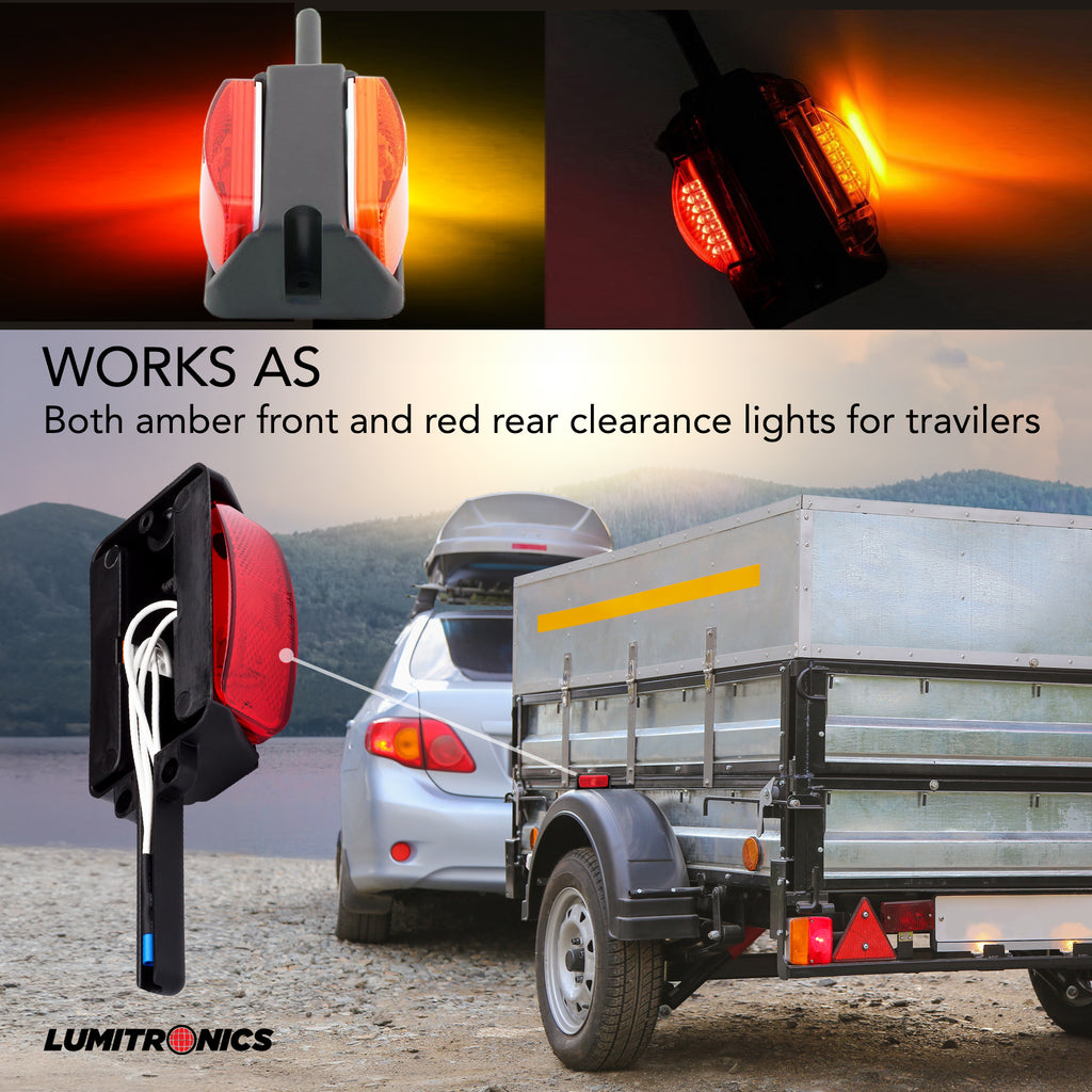 Amber front and red rear clearance lights for travelers with a mountainous background.